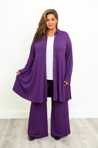 Medium studio shot of an open purple long-sleeve tunic blouse with cuffed sleeves and a panel yoke design.