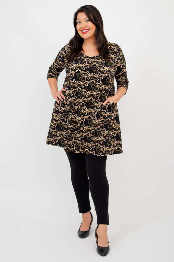 Veronica A-Line Tunic with patch pockets, three-quarter sleeves and vine print, hands on hips