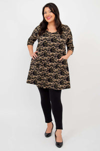 Veronica A-Line Tunic with patch pockets, three-quarter sleeves and vine print, hands on hips