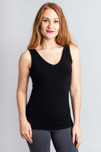 Woman modeling a black bamboo tank top with a V-neckline and grey leggings