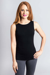 Woman wearing a black bamboo tank top with a scoop neckline and grey leggings