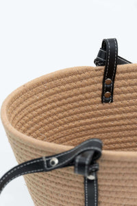 Black strap attachment with stitching on tan cotton tote bag