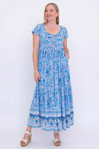 Woman modeling blue boho maxi dress with pockets and flutter sleeves, front view
