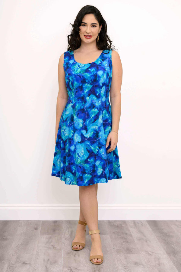 Woman wearing a sleeveless blue floral A-line dress with scoop neckline