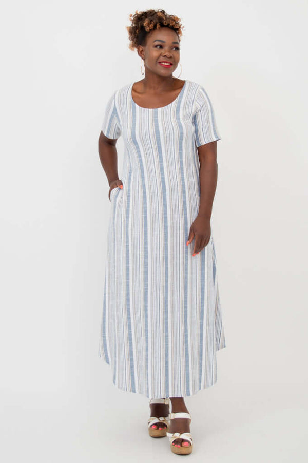 Woman wearing a blue and white striped maxi dress with short sleeves and pockets