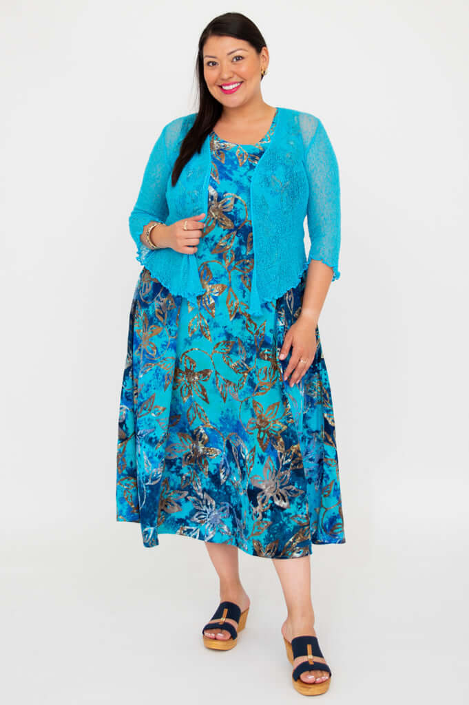 Model wearing a blue floral A-line midi dress paired with a blue cardigan