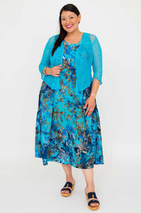 Model wearing a blue floral A-line midi dress paired with a blue cardigan