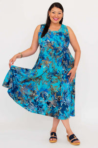 Model smiling in a blue floral A-line midi dress, holding out the skirt