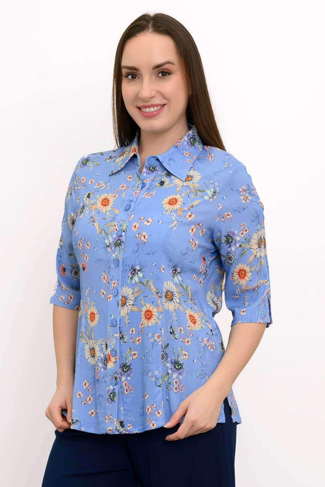 Model wearing a blue floral button-front blouse with elbow-length sleeves