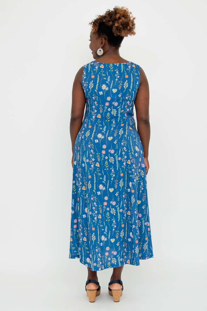 Back view of woman in blue floral maxi dress, showing dress detail