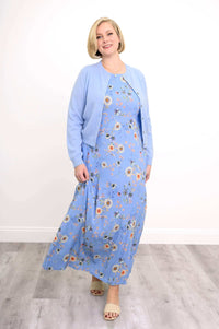 Woman moving in a blue floral shift maxi dress paired with a light blue cardigan