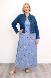 Woman wearing a blue floral shift maxi dress layered with a denim jacket