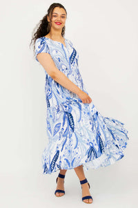 Woman twirling in a blue paisley maxi dress with short sleeves