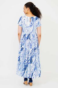 Back view of a woman in a blue paisley tiered maxi dress