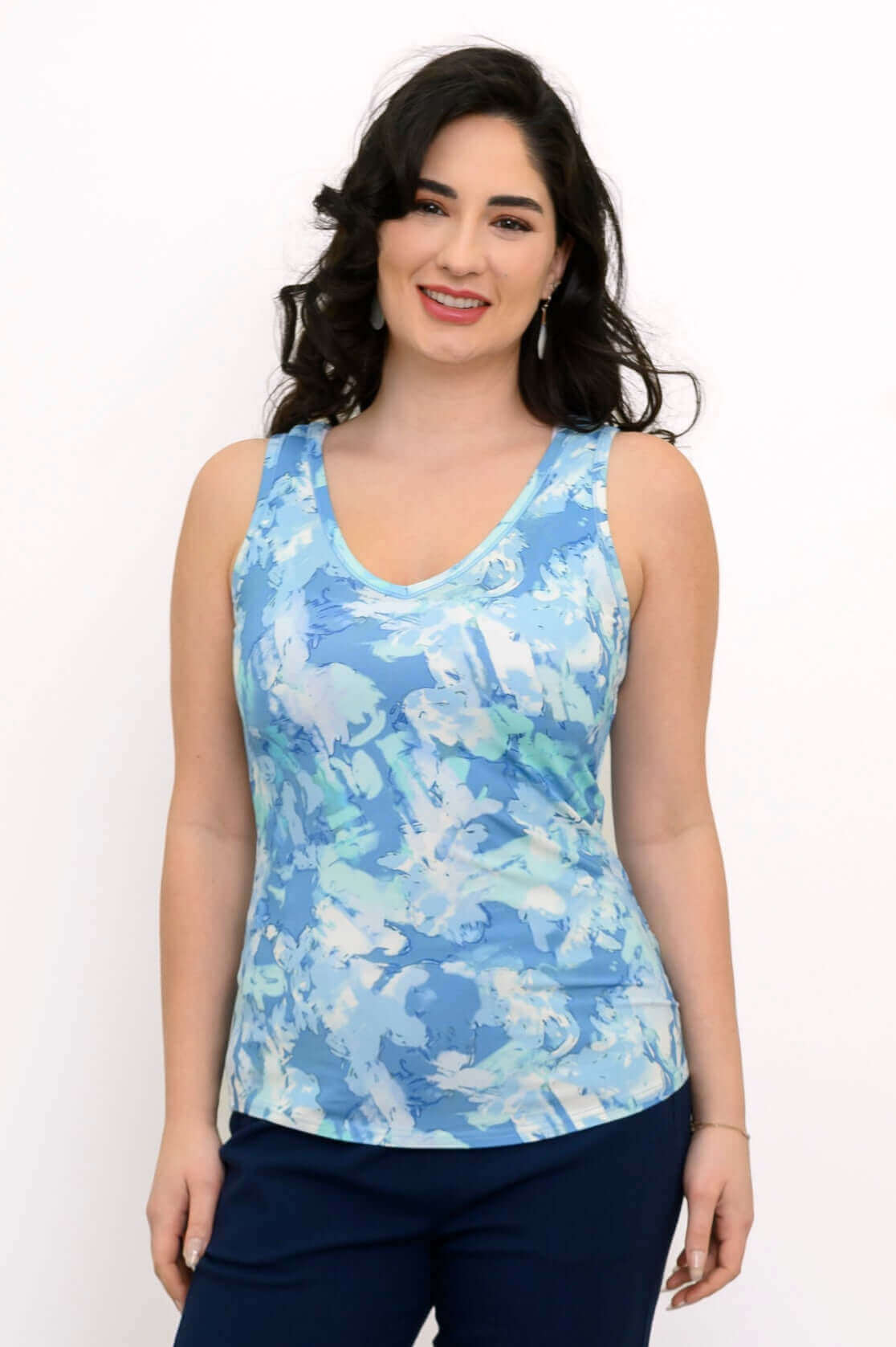 Woman wearing a blue reversible bamboo tank top with abstract print, front view