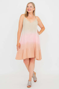 Woman posing with hand on hip in sleeveless ombre dress with ruffle hem