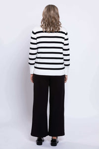 Back view of woman wearing a Breton stripe V-neck sweater, showing ribbed hem and cuffs