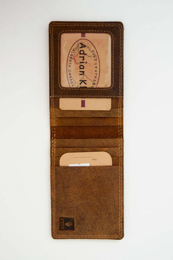 Open brown buffalo leather wallet showing multiple card slots and ID window