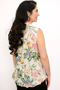 Back view woman wearing multicolor tropical print sleeveless top with green pants on a white background