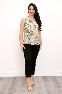 Front view woman wearing multicolor tropical print sleeveless top with green pants on a white background