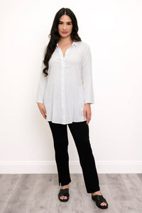 Full body front view of woman wearing a white collared blouse and slim black pants
