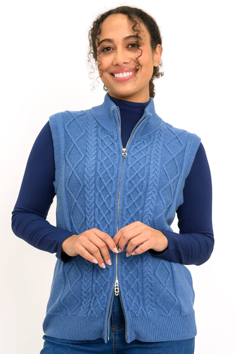 Women's dark blue knit layering vest with a zip-front closure and protective high collar, on a white backdrop.