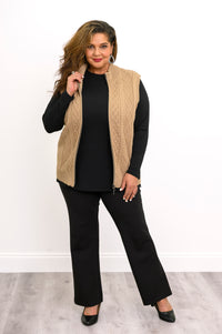 Front-facing view of a women's neutral-toned zip-up layering vest and black pants, showcasing a relaxed fit.