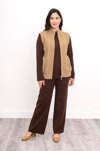 Front view of a women's cotton zip-up vest in a light tan shade, showcasing a comfortable layered autumn outfit.