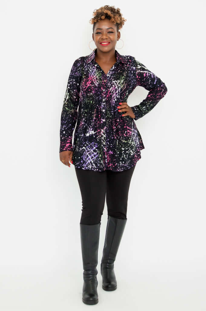 Full body view of a woman modeling the Cindy smocked shirt paired with black pants and boots