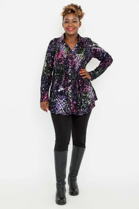 Full body view of a woman modeling the Cindy smocked shirt paired with black pants and boots