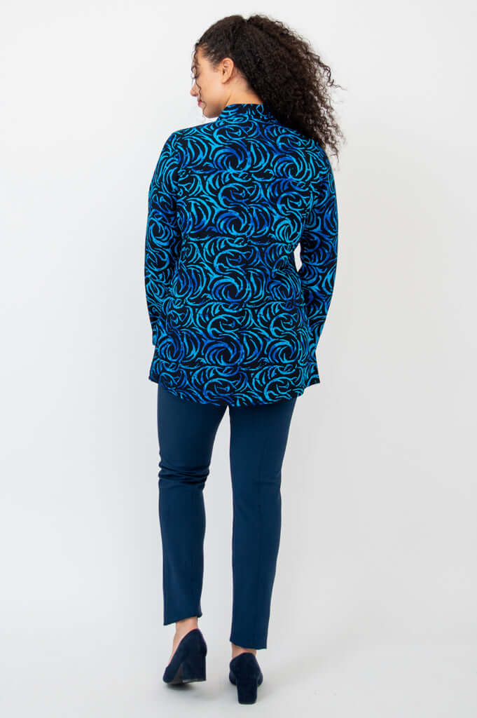 Back view of model displaying the Cindy shirt's bold blue swirl print