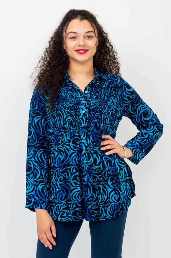 Front view of model wearing the Cindy shirt with blue swirl pattern and navy pants