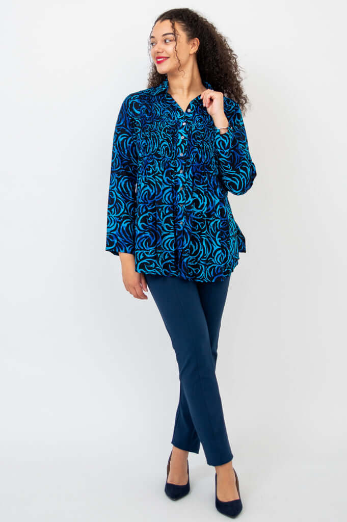 Model looking to the side in Cindy shirt and navy trousers, hand near collar