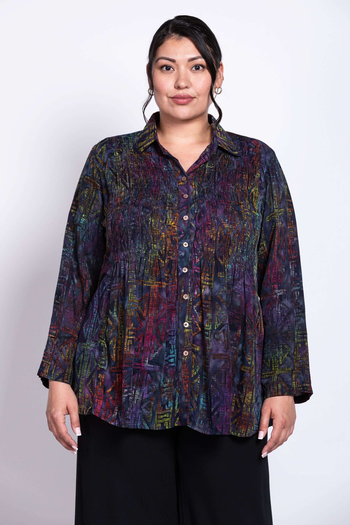 Front view of model wearing a Cindy shirt with multicolor abstract pattern, long sleeves, and a small collar