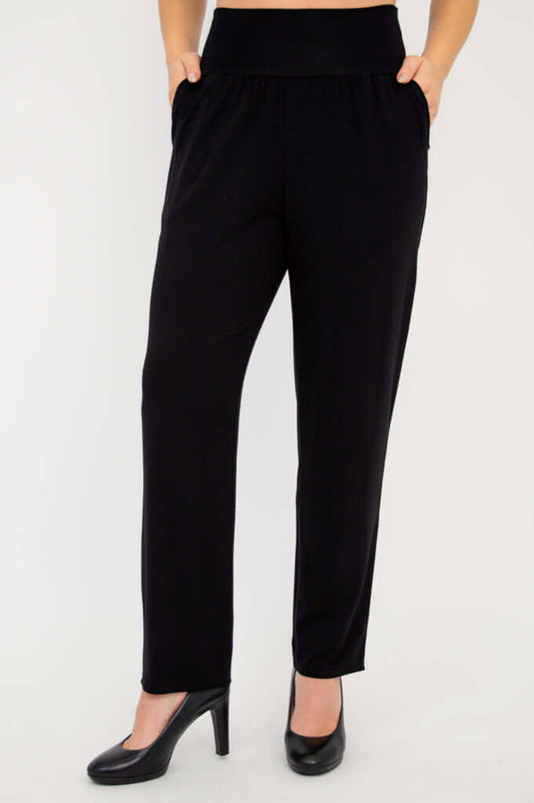 Clair bamboo pants in black, hands in deep pockets, wide waistband