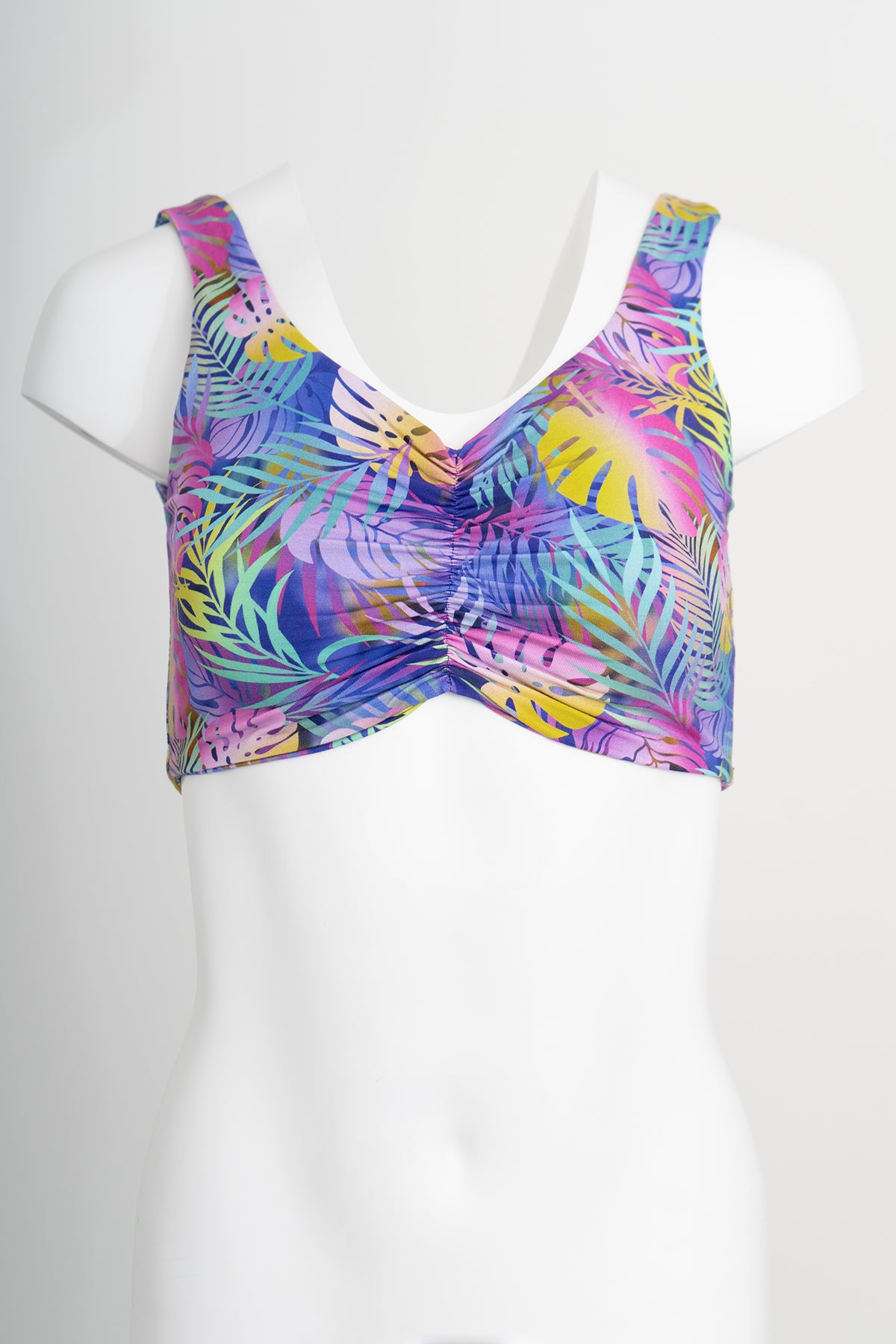 Front view of multicolour tropical leaf patterned bra on a white background
