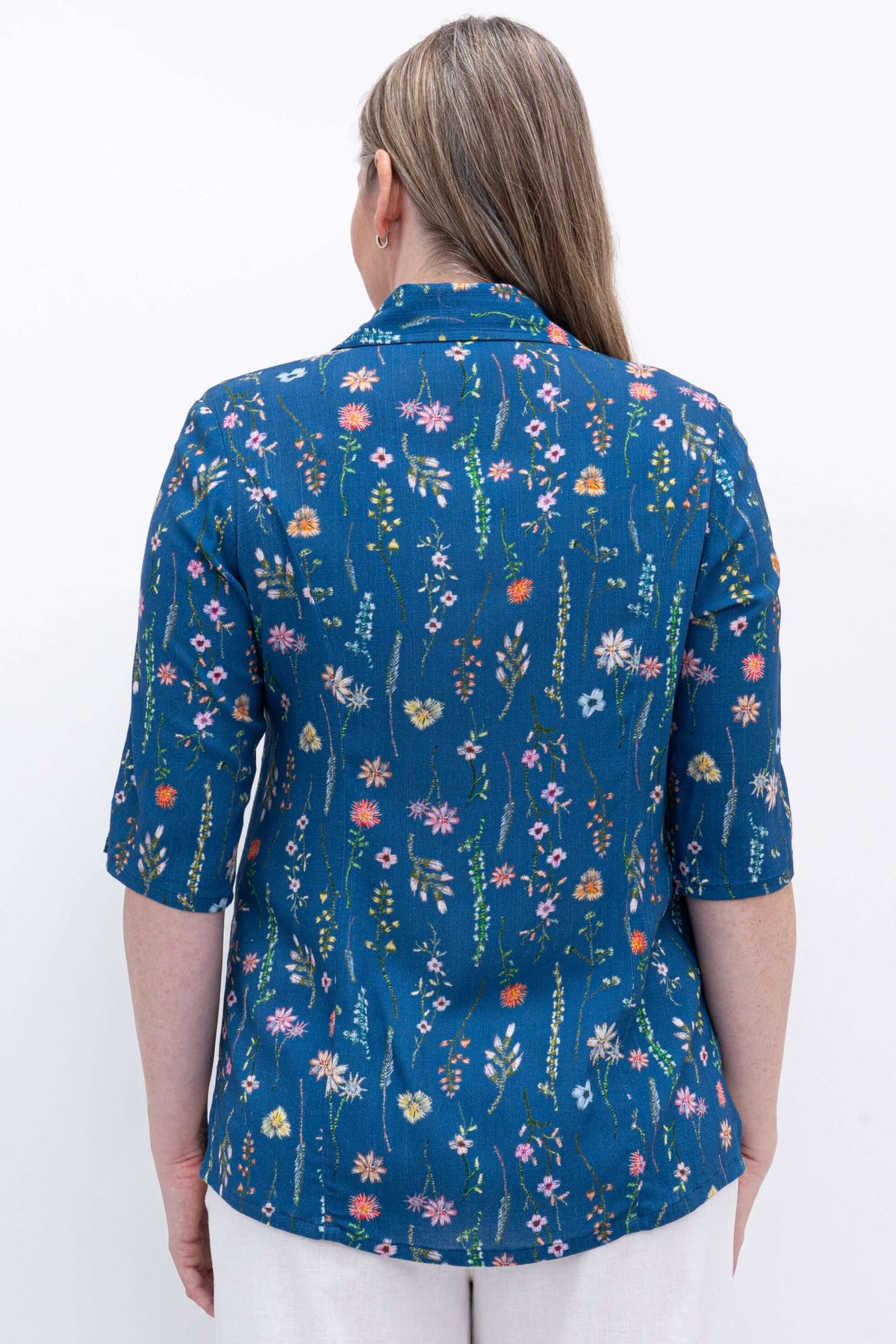 Close-up of the back of the blue floral button-up blouse with princess seams