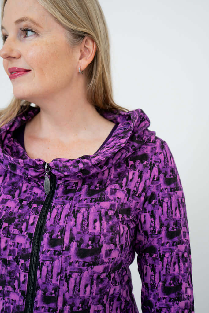 Close-up of Seymour hoodie, showing cowl neck detail in purple print