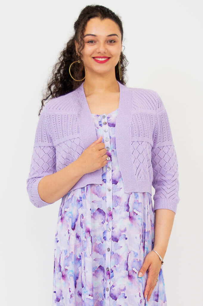 Close-up front view of woman wearing lilac pointelle knit cropped cardigan