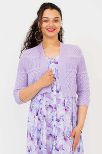 Close-up front view of woman wearing lilac pointelle knit cropped cardigan