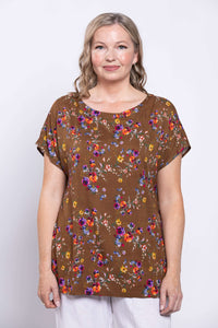 Close-up front view of model wearing a brown floral Aria Tee with dolman sleeves