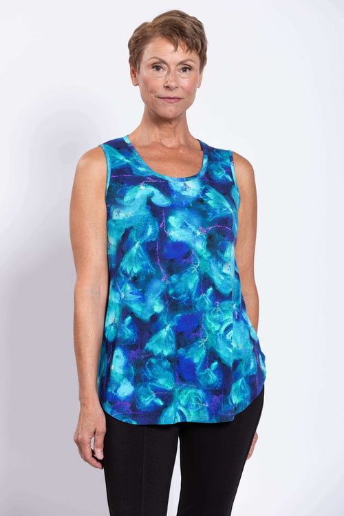 Close-up of woman wearing a sleeveless blue watercolor-patterned bamboo tank top
