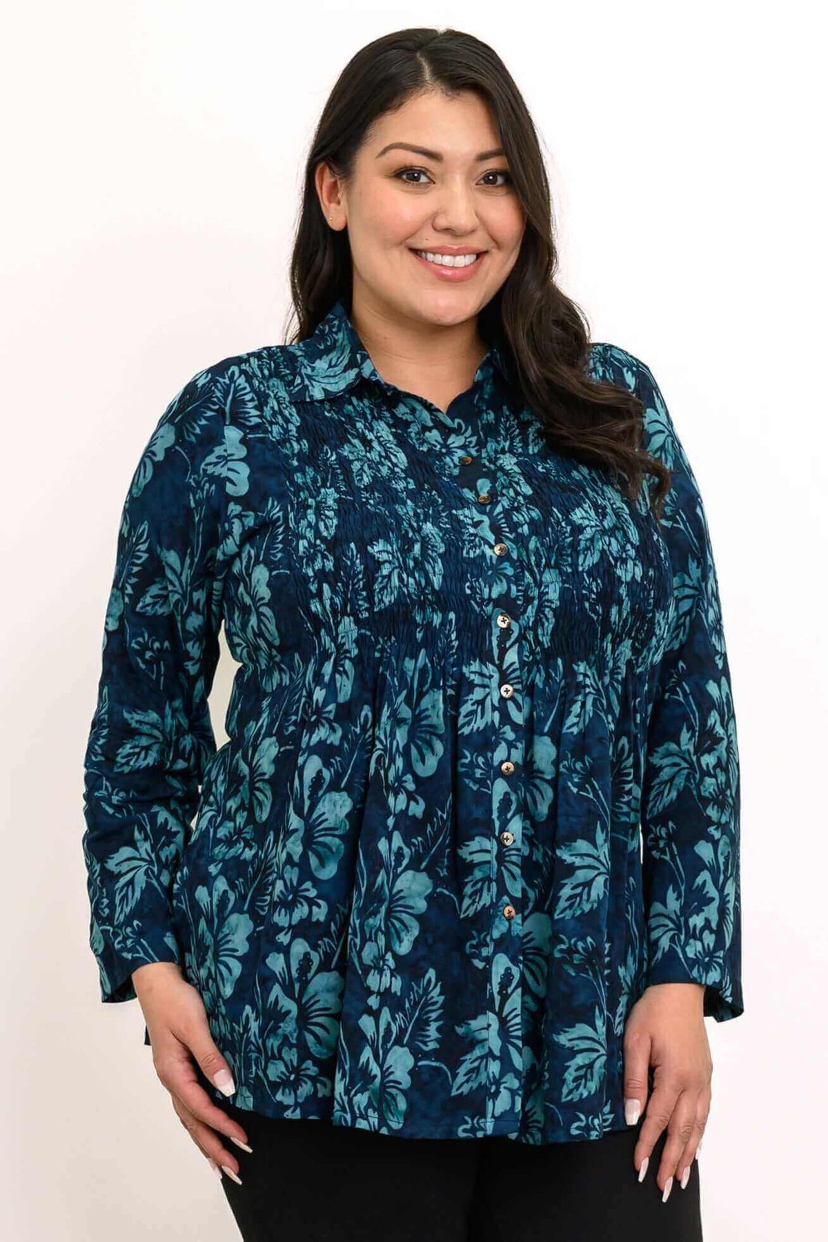 Close-up of woman wearing The Cindy blue floral smocked top with buttons