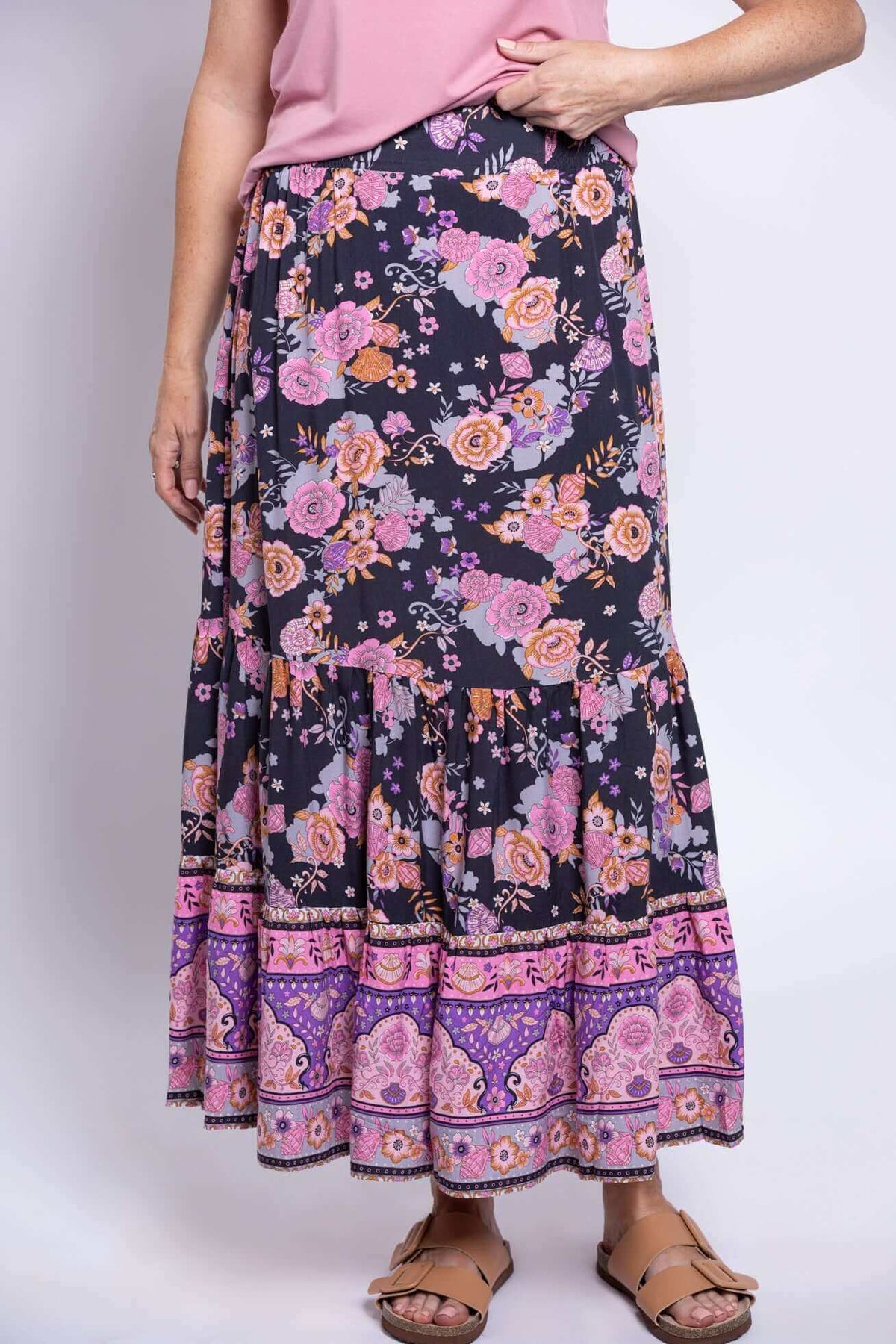Close-up of Tibby floral skirt with purple and pink flowers and tiered hem