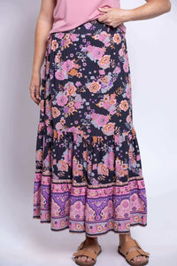 Close-up of Tibby floral skirt with purple and pink flowers and tiered hem