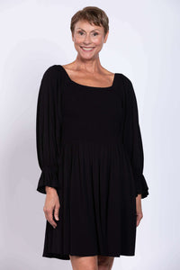 Close-up of model in black dress with square neckline and textured bodice