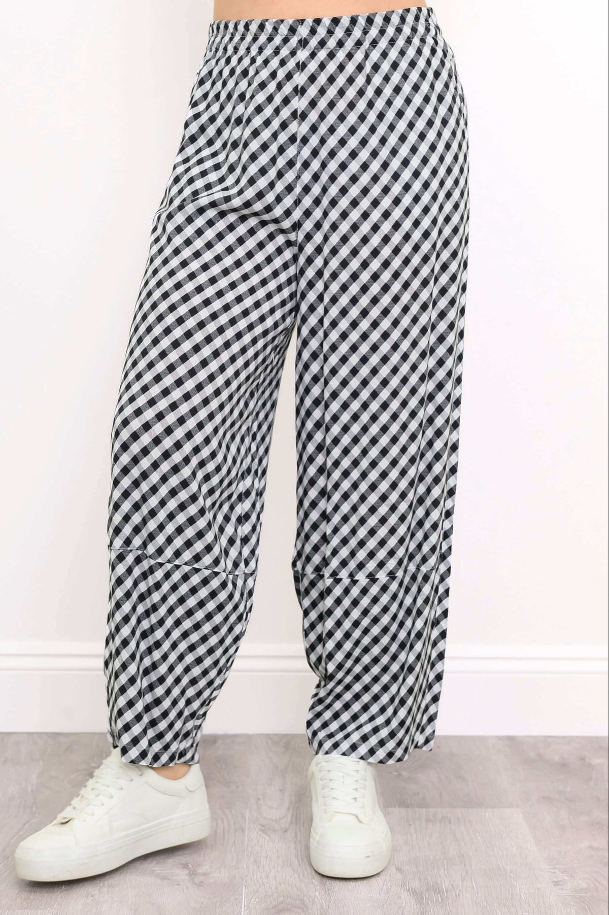 Close-up of boardwalk pants showing black and white gingham pattern and barrel-leg fit