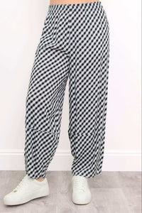 Close-up of boardwalk pants showing black and white gingham pattern and barrel-leg fit
