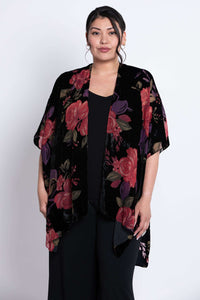 Close-up of model wearing floral velvet kimono wrap over a black outfit