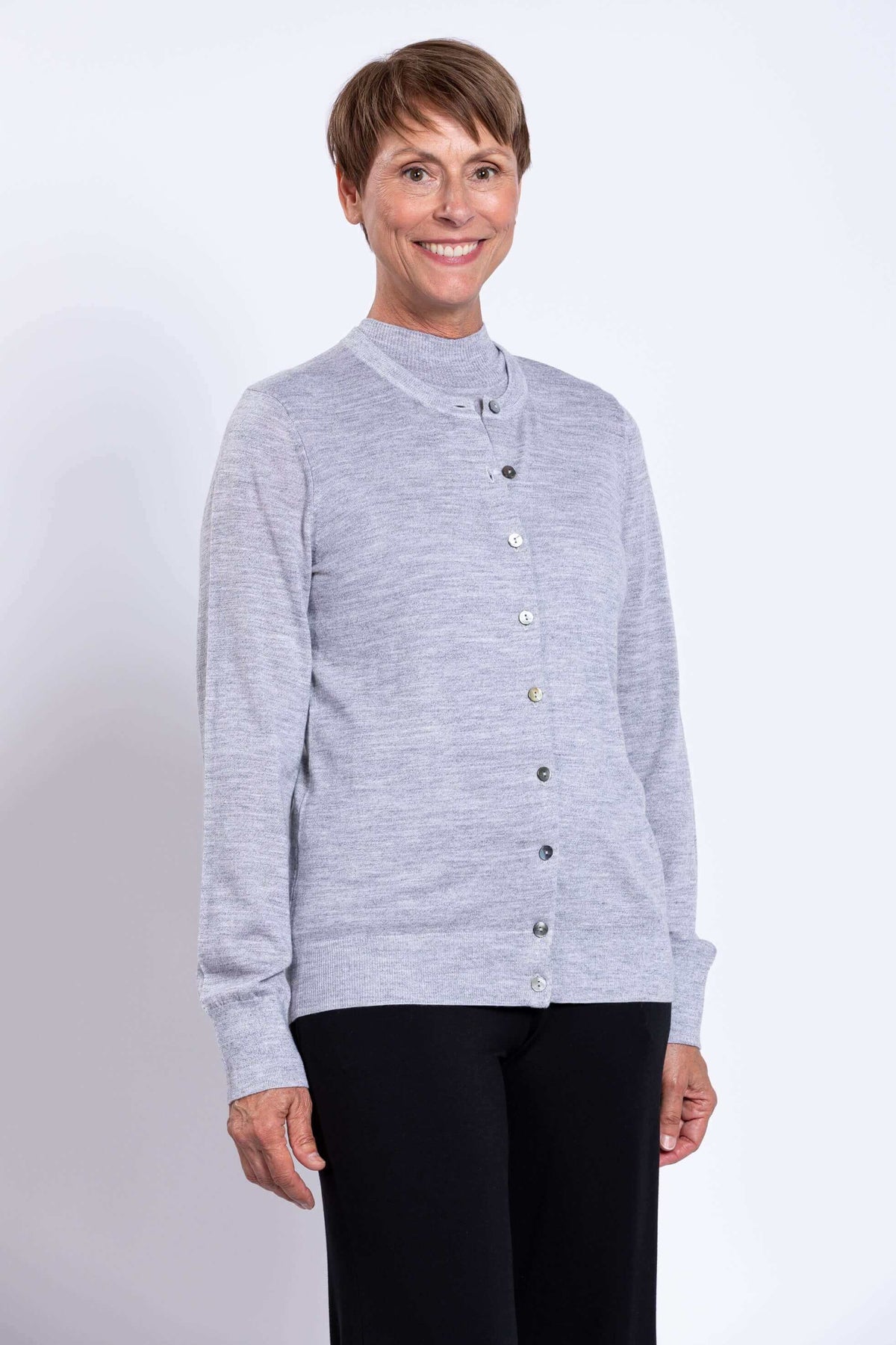 Close-up of a light grey merino wool cardigan with button details